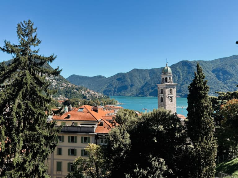 What to Do in Lugano in One Day: Day Trip Itinerary 3 a view of a lake and mountains from a hill