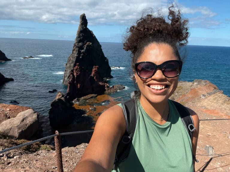 18 Epic Things to Do in Madeira, Portugal 2 Woman taking a selfie on the Ponta de São Lourenço peninsula in Madeira, with volcanic rock formations and the ocean behind her.